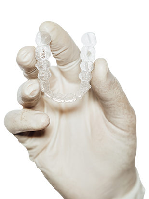 dentist-holding-clear-dental-aligner